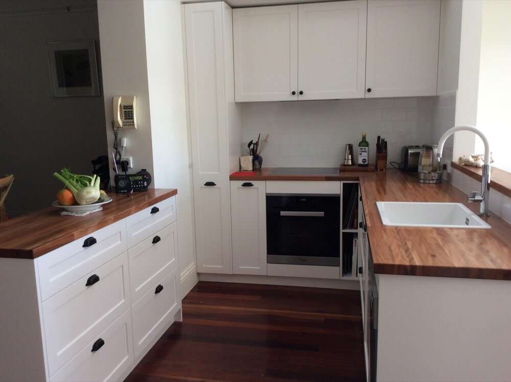 White Classic Contemporary Kitchen with Wooden benchtops and wooden floor